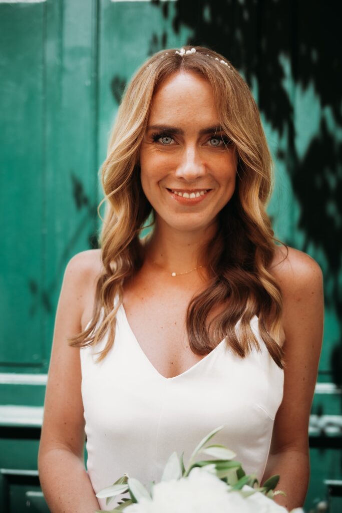 braut schaut glücklich in die kamera bei ihrem fotoshooting nach der hochzeit in heidelberg